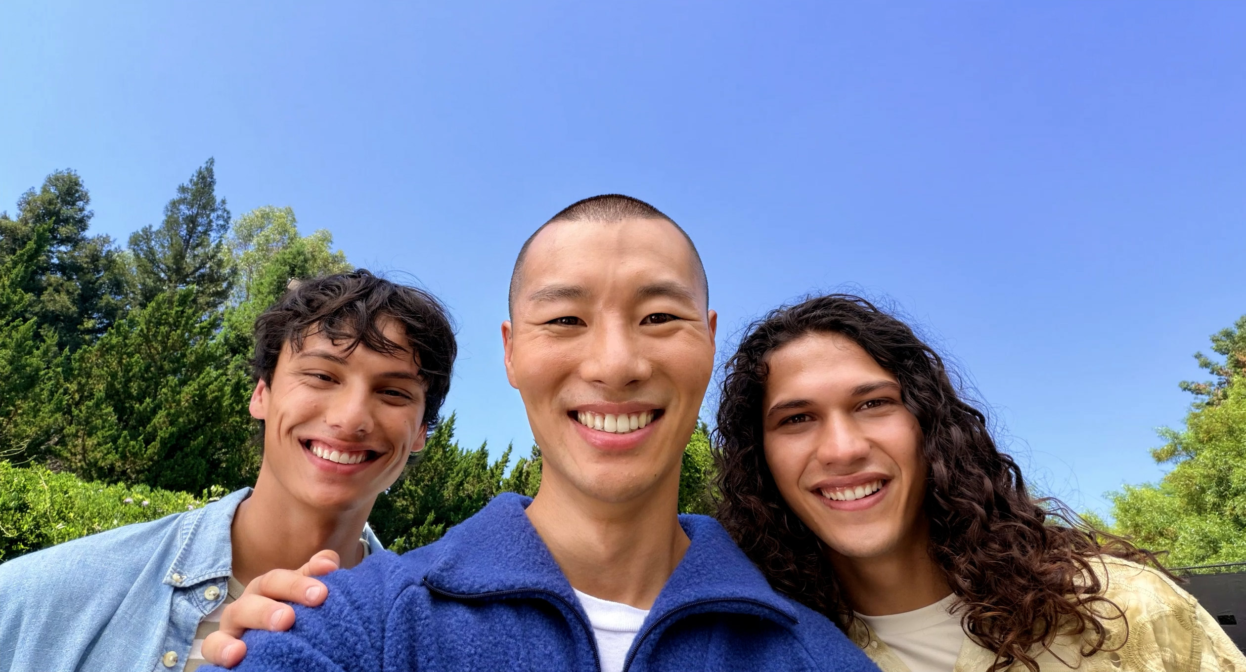 Two boys and one girl taking a selfie with iPhone 17 front camera